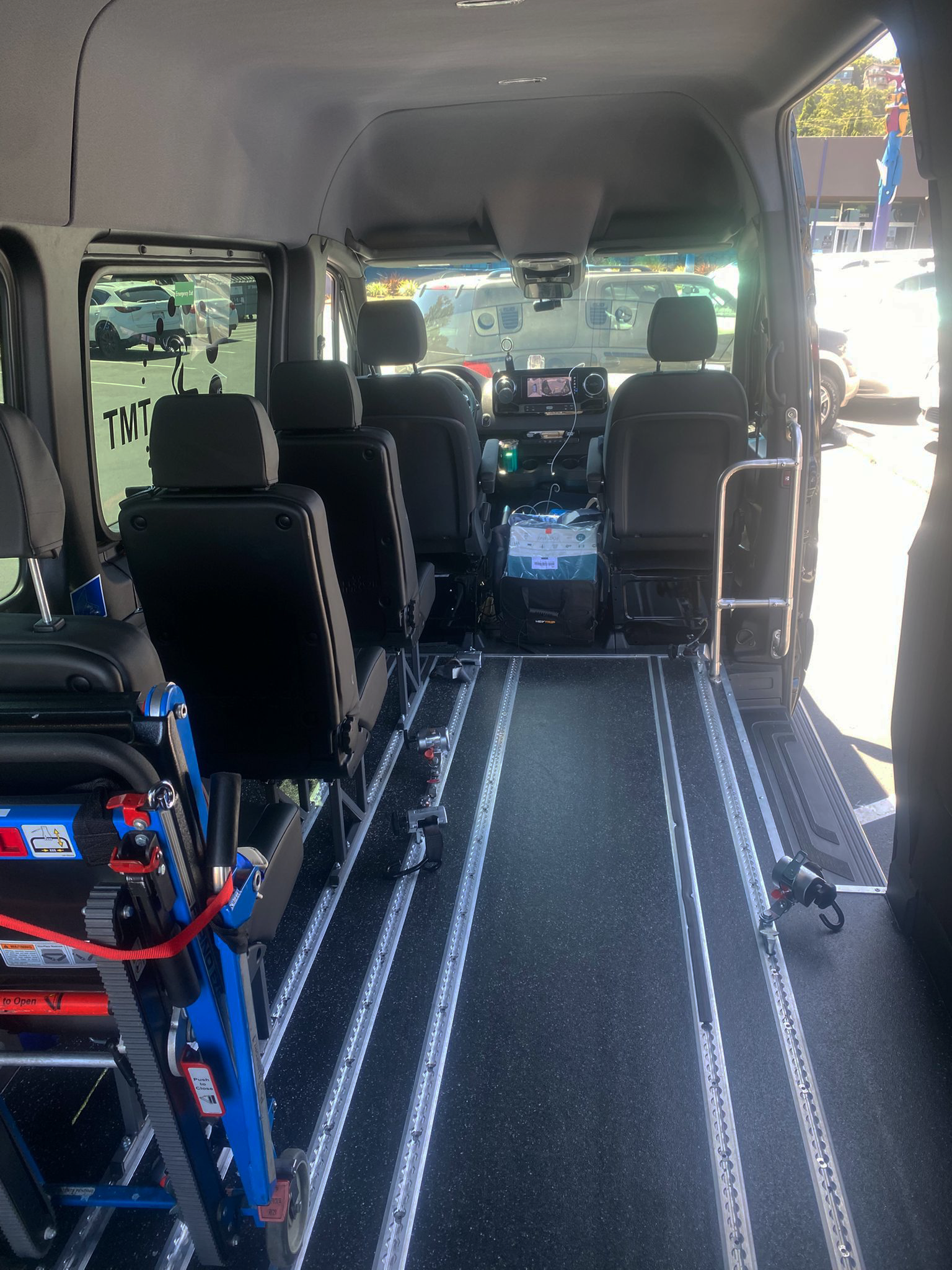 Medical transport van interior showing wheelchair accessibility and medical equipment